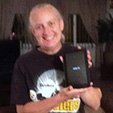 A female standing hold a tablet she won